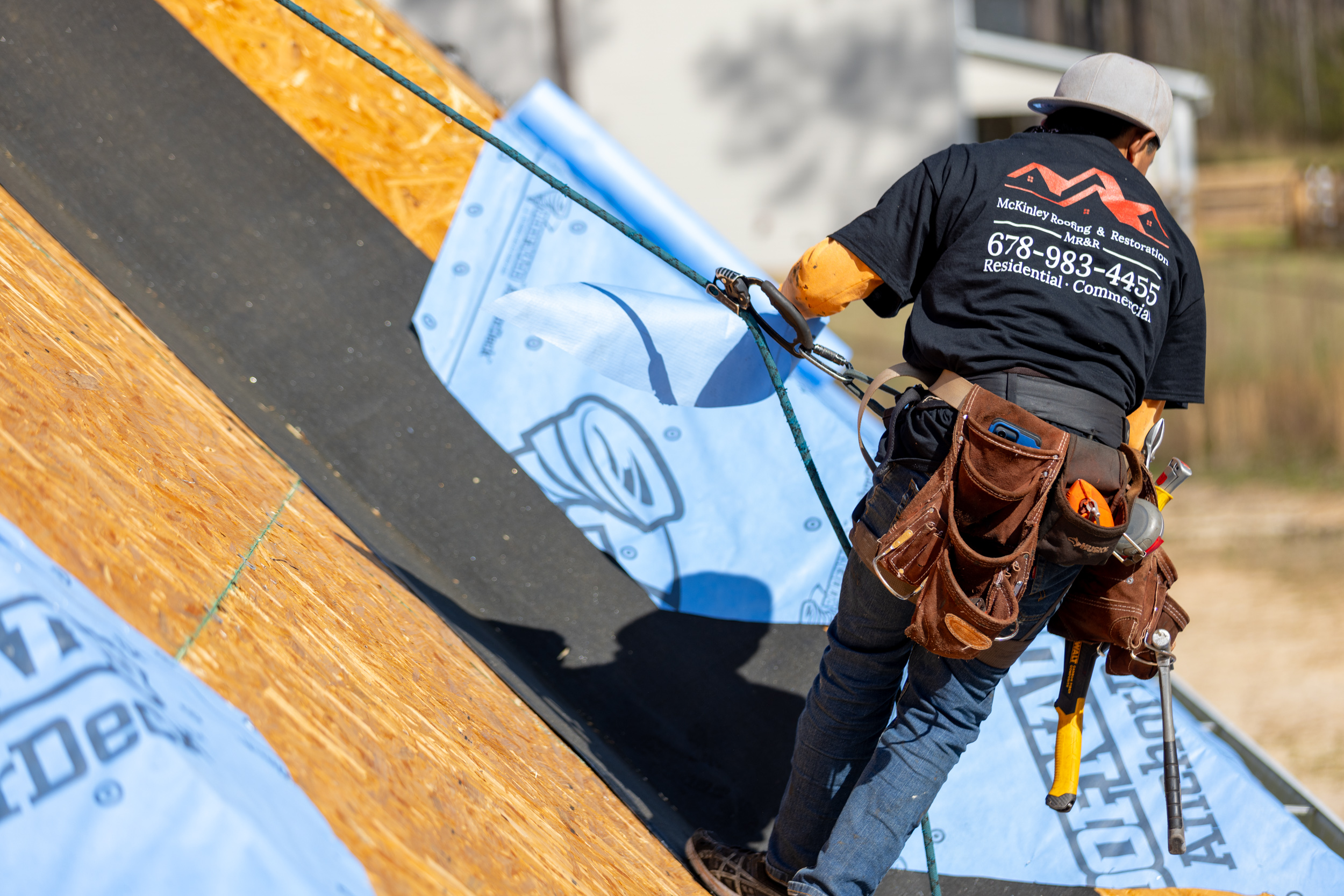 Roofer laying underlayment